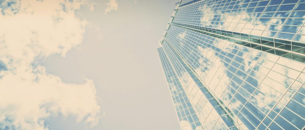 A stunning skyscraper in London, Ontario reflecting clouds on its glass facade.
